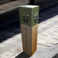 Bollard cover with logo and Pick Up Here printed on each face, on a sidewalk