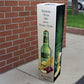 Bollard cover advertising a drink outside a store