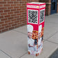 Full-color bollard cover for a pizza shop with a QR code to order