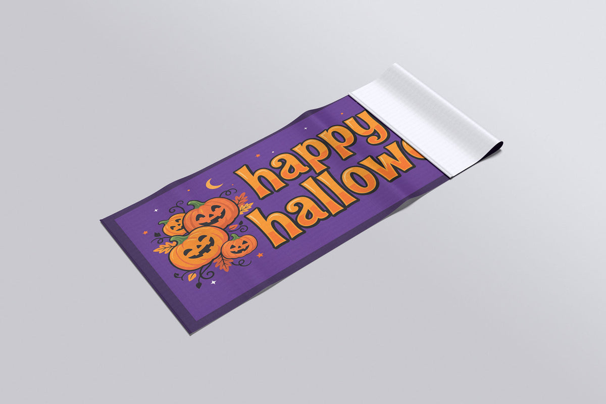 Custom 3x6 Halloween vinyl banner shown rolled, from Beaver Slaps